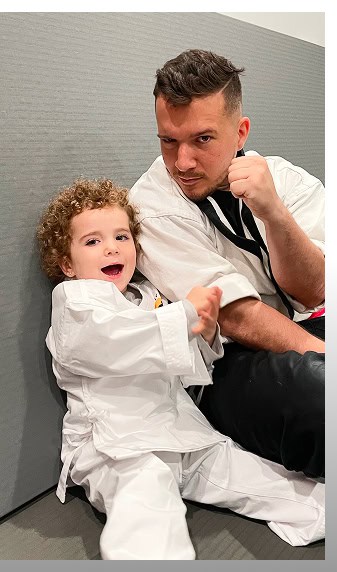 Young child practicing martial arts with instructor Johnny Karate NYC.