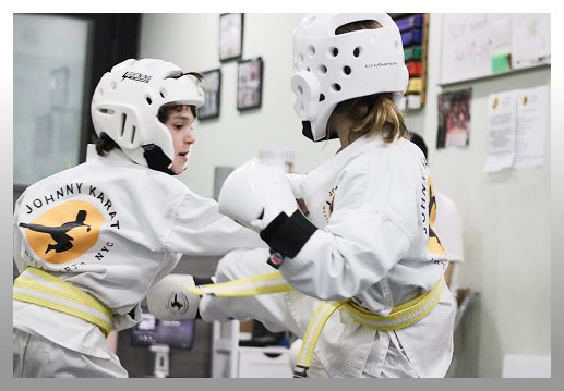 Kids practicing Taekwondo sparring at Johnny Karate NYC martial arts class.