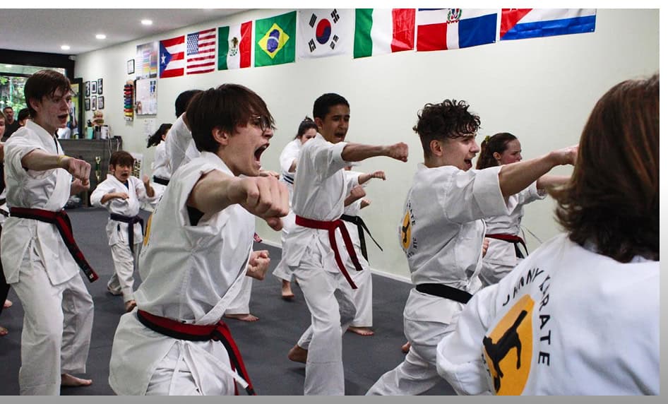 Kids practicing martial arts in a class at Johnny Karate NYC dojo.