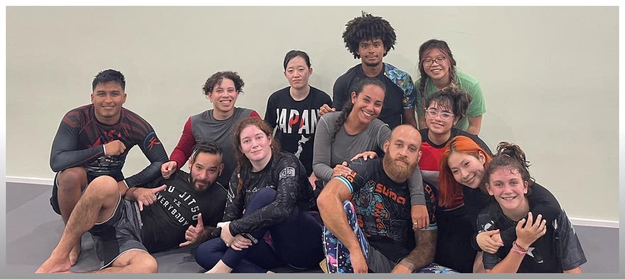 Group of diverse adults practicing martial arts at Johnny Karate NYC studio.