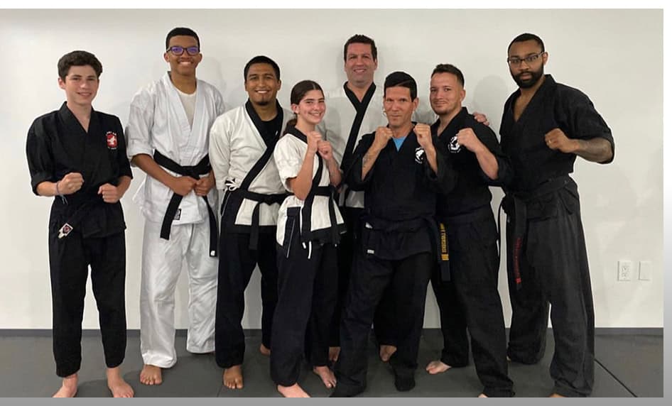 Group of martial artists in uniform at Johnny Karate NYC dojo.