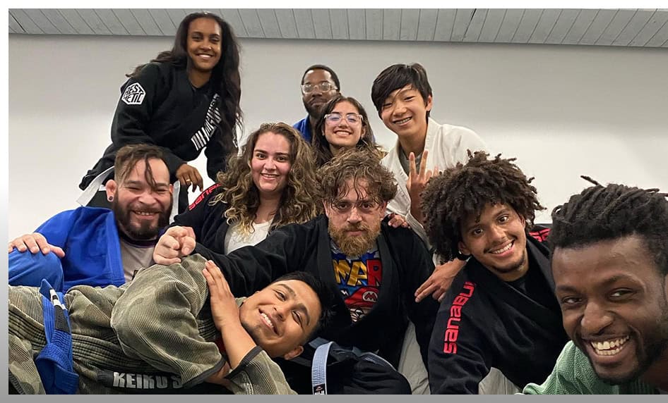 Group of diverse adults practicing martial arts at Johnny Karate NYC studio.