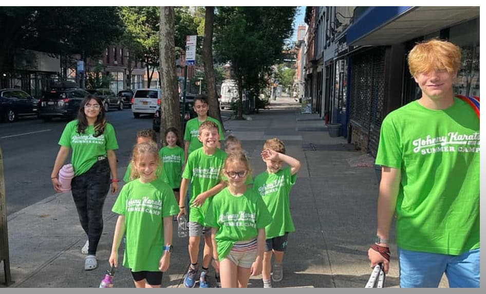 Outdoor group of children and teens participating in Johnny Karate NYC summer camp activities in the.