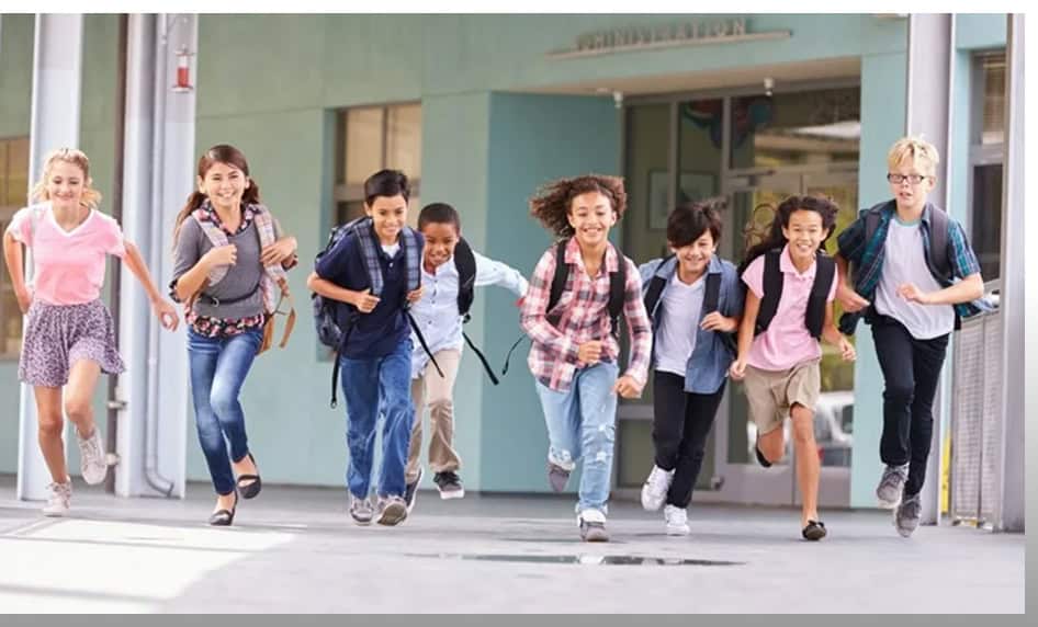Group of happy children running outside school after school program in NYC.