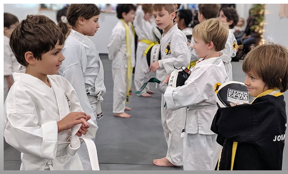 Kids martial arts class at Johnny Karate NYC, children in gi uniforms practicing martial arts.