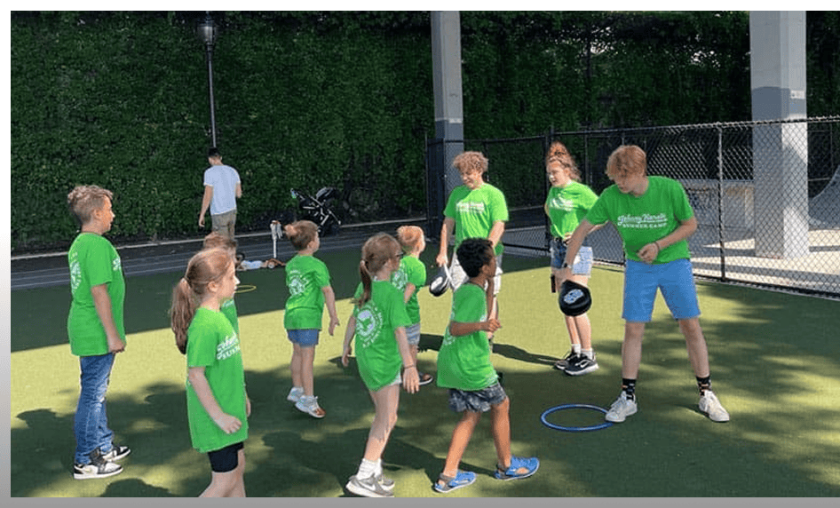 Children participating in outdoor sports activities at Johnny Karate NYC summer camp.