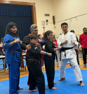 Martial arts students practicing techniques with instructor in NYC dojo.