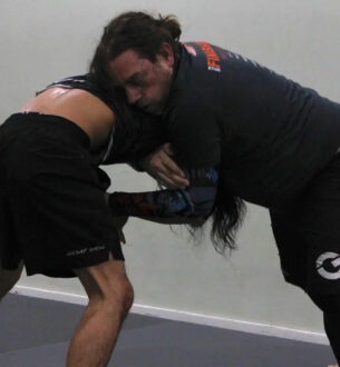 Two men practicing Brazilian Jiu-Jitsu at Johnny Karate NYC gym.
