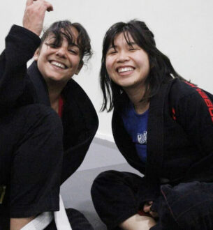 Two women practicing Brazilian Jiu-Jitsu at Johnny Karate NYC gym.