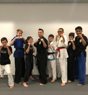 Teen martial arts training at Johnny Karate NYC with JMA Teen BJJ students practicing self-defense.