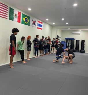 Young students practicing Brazilian Jiu-Jitsu techniques at Johnny Karate NYC, focusing on disciplin.