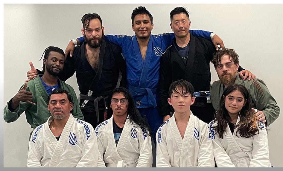 JMA Teen BJJ team with instructors at Johnny Karate NYC, showcasing martial arts skills and teamwork.