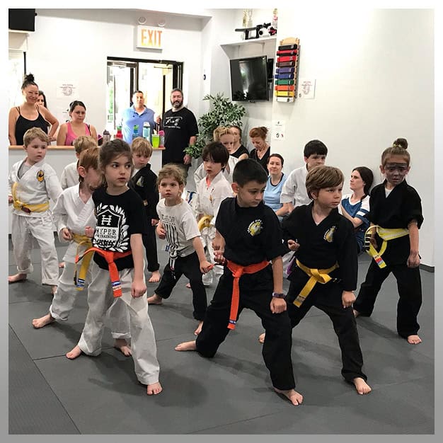 Kids martial arts class practicing martial arts techniques at Johnny Karate NYC.