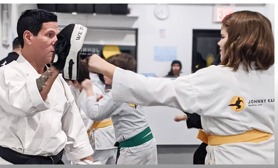 Teen martial arts class practicing punching techniques at Johnny Karate NYC.
