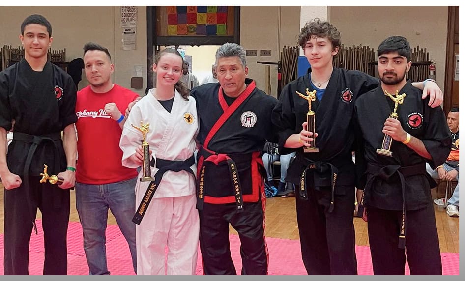 Young martial artists with Johnny Karate NYC holding trophies after a martial arts class.