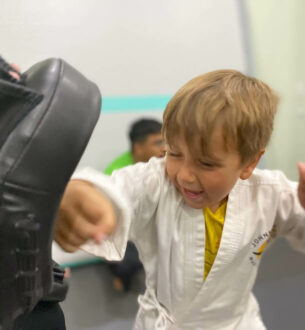Young boy practicing martial arts in a class at Johnny Karate NYC.