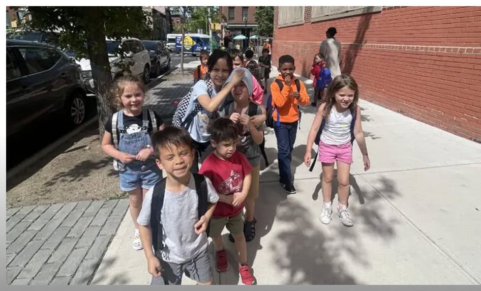 Children walking outdoors after school program in NYC.