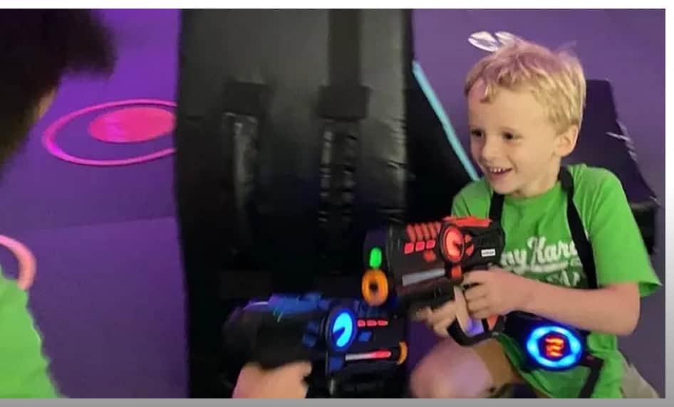 Kids playing laser tag at Summer Camp Johnny Karate NYC, enjoying an exciting outdoor activity.