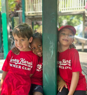 Kids enjoying summer camp activities at Johnny Karate NYC in vibrant red T-shirts.