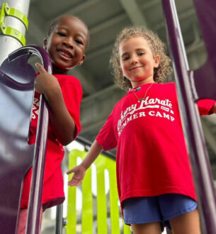 Kids enjoying summer camp activities at Johnny Karate NYC in vibrant red shirts.