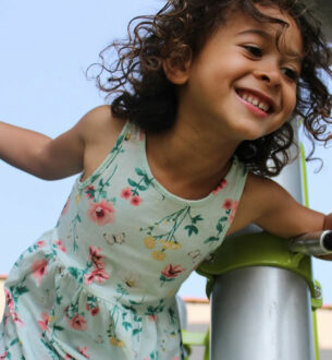 Child enjoying outdoor activities at summer camp, smiling and having fun.