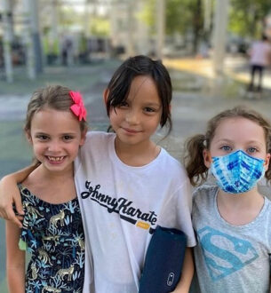 Kids enjoying summer camp activities at Johnny Karate NYC in a park setting.