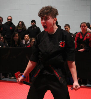 Young martial artist demonstrating a powerful move at Johnny Karate NYC.