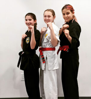 Young girls practicing martial arts in karate uniforms, demonstrating confidence and discipline.