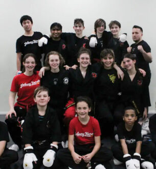 Group of teens practicing martial arts at Johnny Karate NYC dojo.