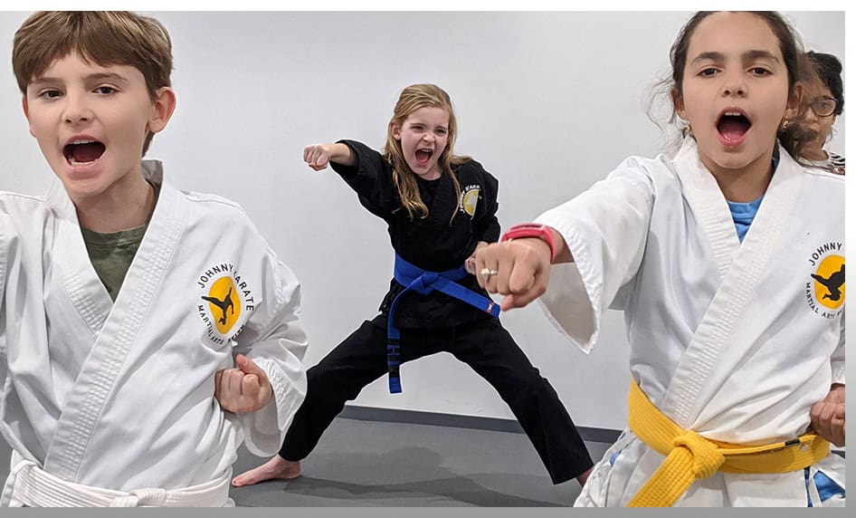 Children practicing martial arts in a kids martial arts class at Johnny Karate NYC.